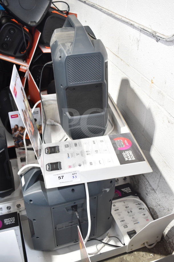3 Ion speakers in store display, grey color, shown with tags indicating "3 times your bid". Good condition, with power cords.