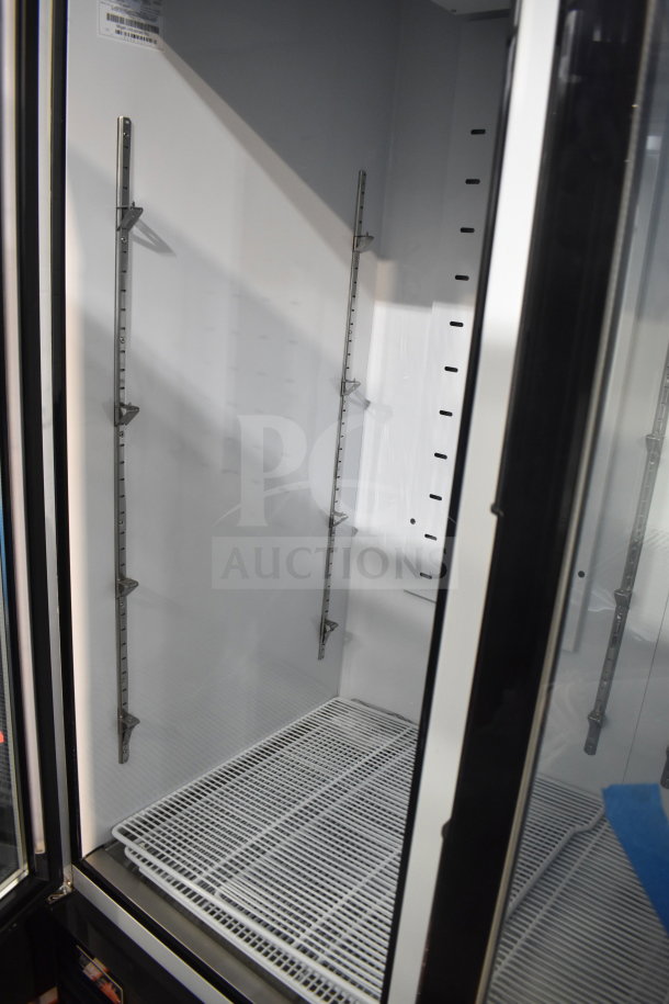 2023 Migali C-49FM-HCe commercial freezer, 3-door, new with minor dents, on casters. Model label visible inside.