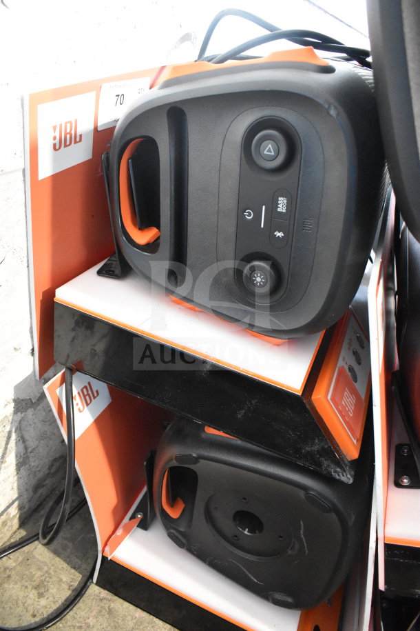Store display featuring JBL speaker with controls visible; orange and black color scheme; used condition; JBL branding.