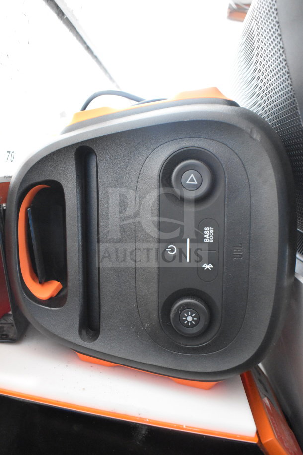 JBL speaker with control panel, featuring bass boost and Bluetooth options, in excellent condition, part of store display set.