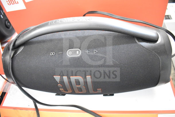JBL Boombox 3 Speaker on display. Features Bluetooth connectivity, durable design, and prominent JBL logo. Excellent condition.