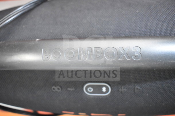 JBL Boombox 3 speaker close-up, showing brand logo and control icons. In excellent condition. Auction includes three displays.