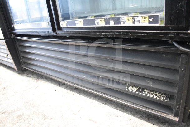 True GDM-49F Commercial 2 Door Reach-In Freezer Merchandiser, tested and working, visible model label, black exterior.