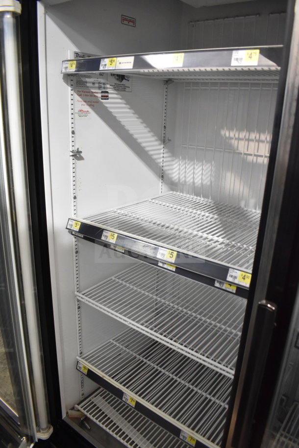 True GDM-49F Commercial 2 Door Reach In Freezer, tested and working; 115/208-230V, 1 phase, shelves labeled with prices.