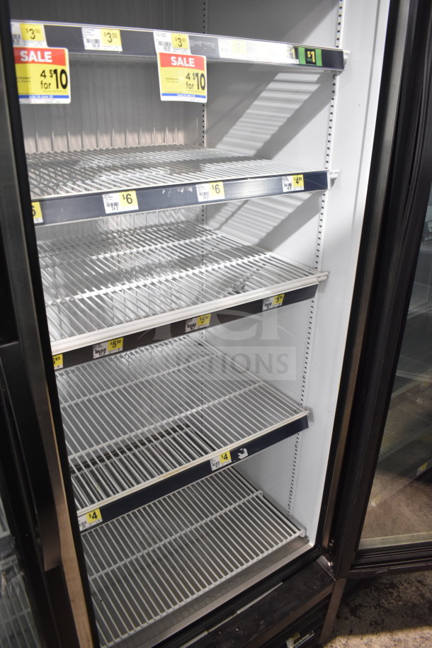 2018 True GDM-49F-HC commercial 2-door freezer merchandiser, tested and working, empty interior with sale price tags visible.