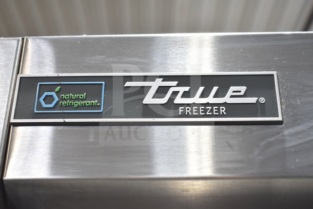2020 True T-49F-HC freezer label showing "True" and "natural refrigerant" logos, stainless steel surface.