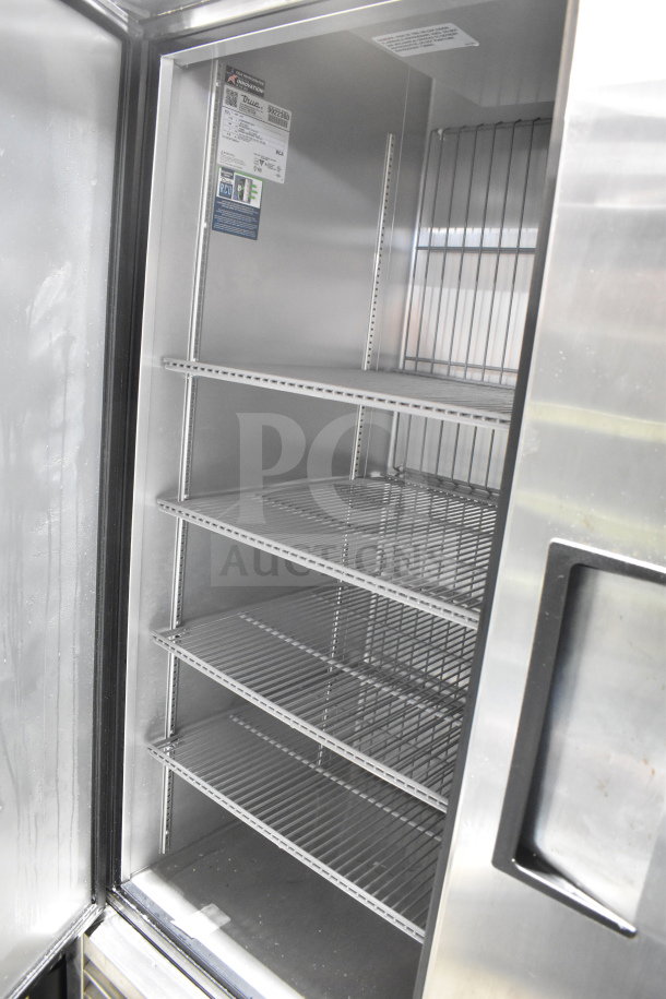 2020 True T-49F-HC commercial 2-door freezer, stainless steel, on casters, 115V, 1 phase, interior shelves visible.