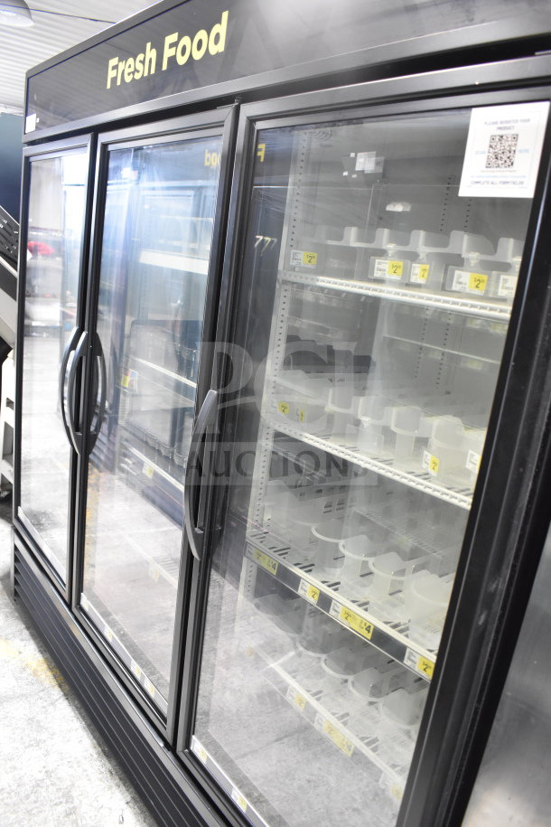 True GDM-72-HC commercial 3-door cooler, glass front, shelves visible, on commercial casters, 115V, well-maintained.