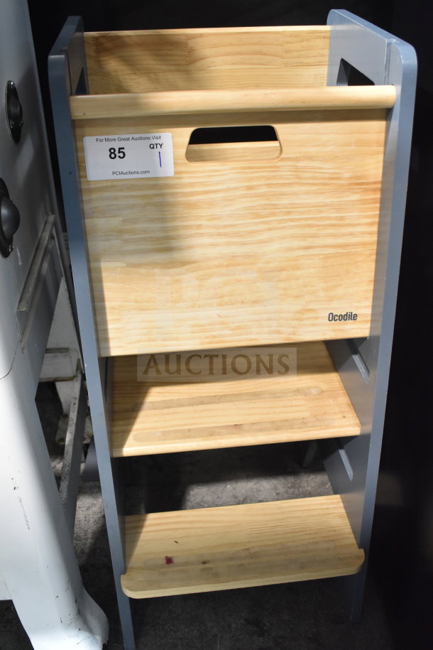 Ocodile Toddler Standing Tower in wood, three steps, sturdy condition, visible brand marking, auction tag attached.