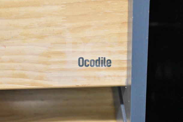 Ocodile Toddler Standing Tower, made of natural wood with a smooth finish. Visible brand marking on the side panel.