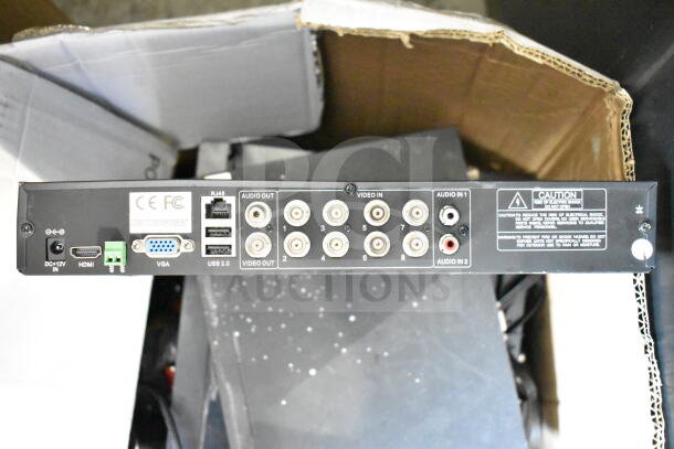 Back panel of a digital video recorder showing multiple video and audio input/output ports, USB 2.0, HDMI, VGA, and RJ45 connections. Caution label present.