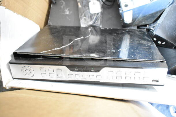 Night Owl 8 Channel 960H DVR showing front panel controls, black top surface with scratches. Includes other electronic items.