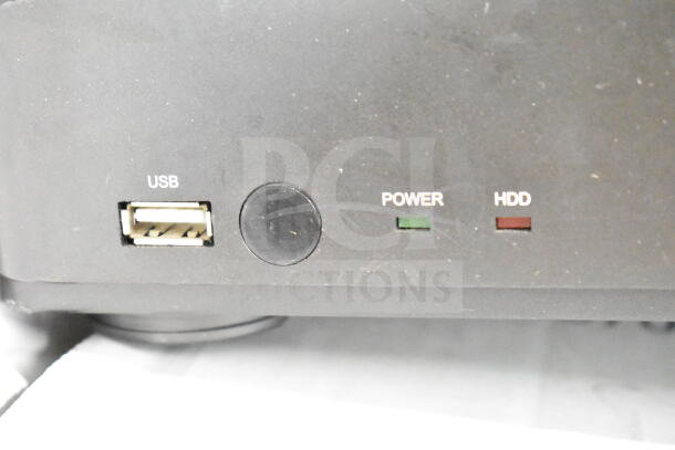 Black DVR panel close-up showing USB port, power indicator, and HDD status light. Suitable for security systems.
