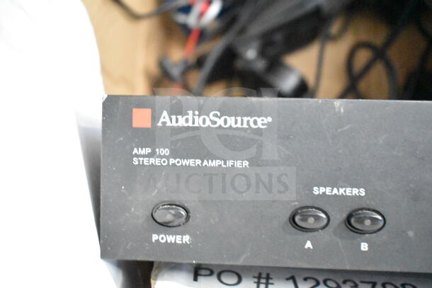 AudioSource AMP100 Stereo Power Amplifier front panel with power and speaker buttons visible.