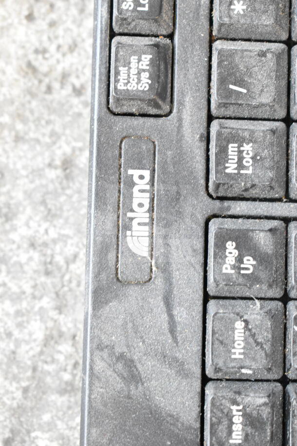 Inland keyboard with visible wear, featuring "Print Screen" and "Num Lock" keys, suitable for tech enthusiasts.