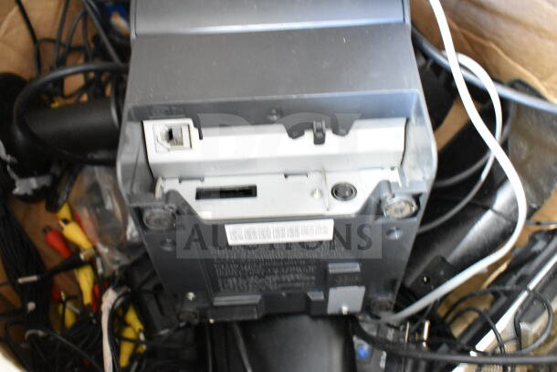 Box of electronics including Night Owl 8 Channel DVR and accessories. Cables and devices visible, condition unclear.