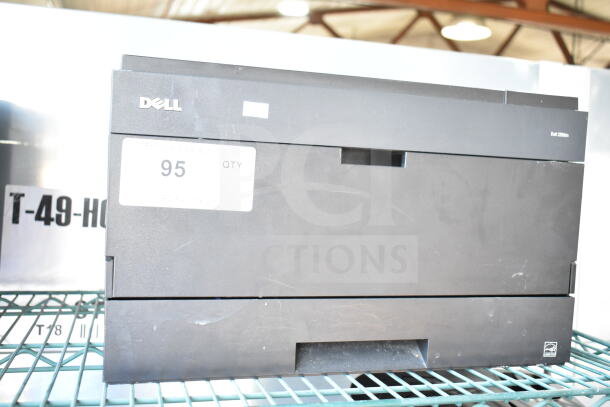 Dell 2350dn countertop printer in black, visible minor wear, located on a metal shelf. Label indicates quantity 95.