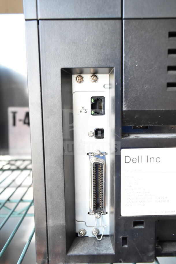 Dell 2350dn countertop printer with connection ports and label. Black finish, used condition. Model and brand visible.