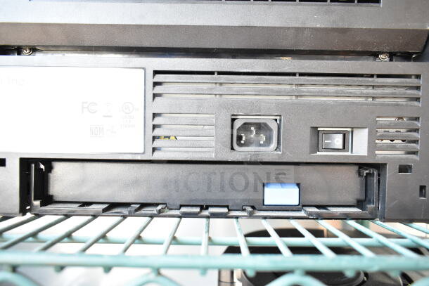 Dell 2350dn Countertop Printer rear view, showing power input and switch. Grille design with certification labels visible.