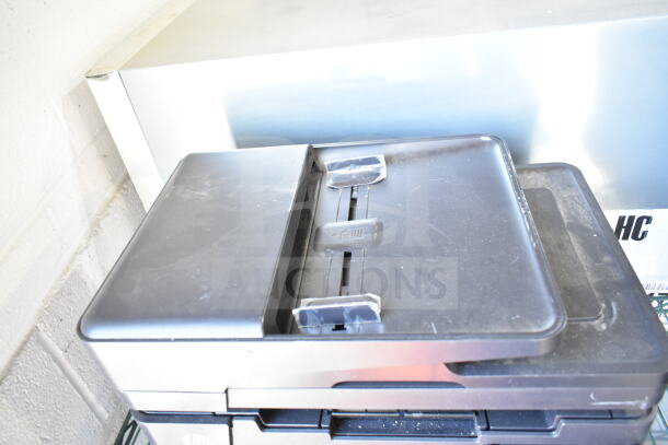 HP LaserJet Pro MFO M127fn countertop printer, black, good condition, visible dust on top surface, compact design.