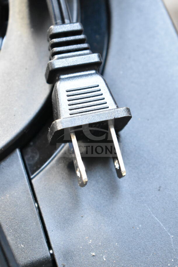Close-up of a power plug from a Ninja CE451 Countertop Coffee Machine. Black plastic plug, in good condition.