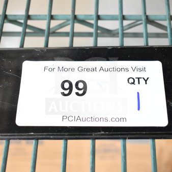 Samsung smartphone with visible screen scratches, auction lot number 99, displayed on metal shelving, PCI Auctions label.