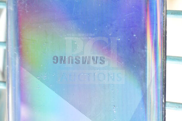 Samsung smartphone back with colorful, striped design and visible brand logo. Good condition.