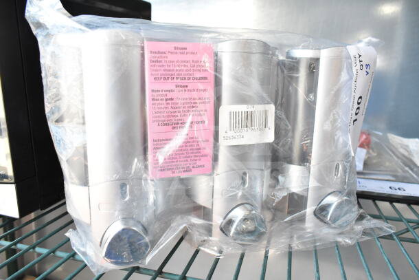 Three-chamber satin silver wall-mounted shower dispenser with ProTerra logo, translucent bottles, and silicone directions label.