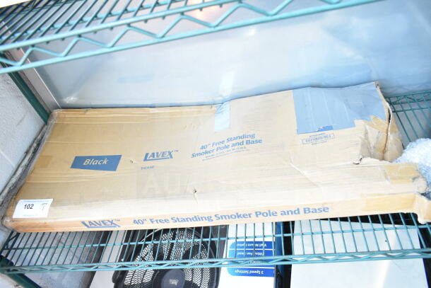 Box containing Lavex 475SP40BK 40" Free Standing Smoker Pole and Base, marked as new with scratches and dents.
