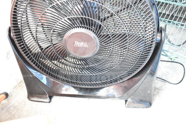 Best Comfort Fan, black, circular grille design, some visible wear. Central label with brand name. Electric cord attached.