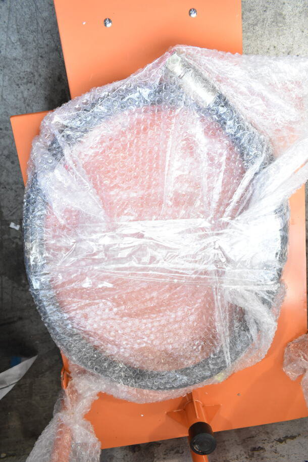Brand new Fryclone Oil Caddy, orange, bubble-wrapped. Scratch and dent condition visible.