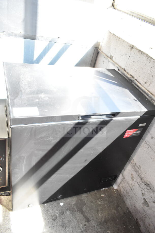 Frigidaire FGFRF7009-BLACK chest freezer, black, garage ready, 115 volts, 1 phase, appears in good condition.