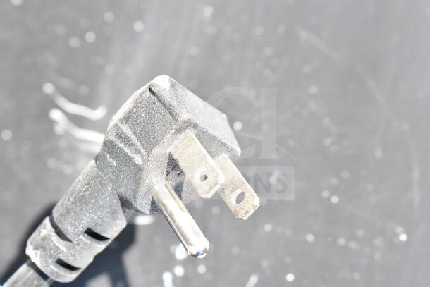 Power plug of Frigidaire FGFRF7009-BLACK Chest Freezer, 115 Volts, 1 Phase. Dust visible on plug surface.
