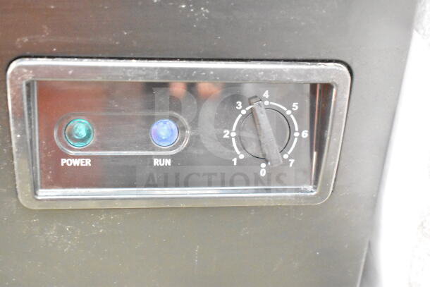 Frigidaire FGFRF7009-BLACK chest freezer control panel with power and run indicator lights and adjustable thermostat.