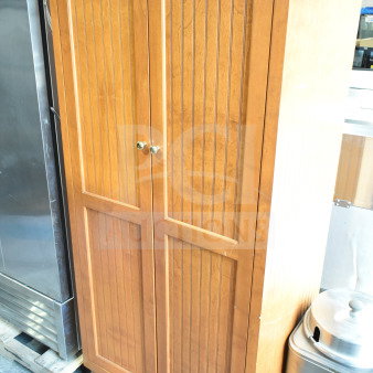 Wood pattern 2-door cabinet with vertical grooves, gold knobs, and sturdy wooden feet. Slight surface wear visible.