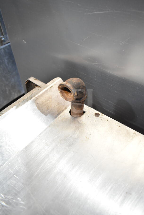 Imperial Commercial Gas Cheese Melter with metal surface and visible gas pipe fitting. Slight wear evident.