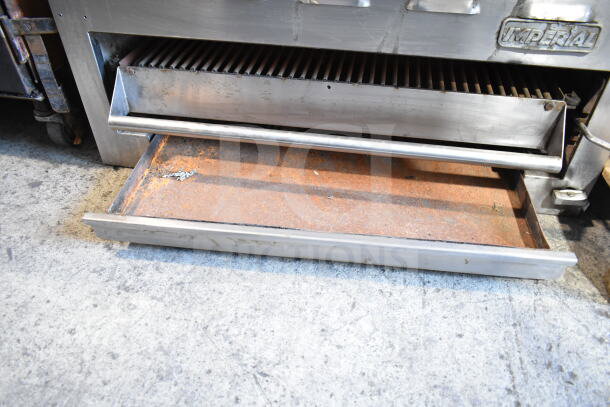 Imperial Commercial Gas Cheese Melter with stainless steel exterior, showing signs of use. Visible Imperial branding.