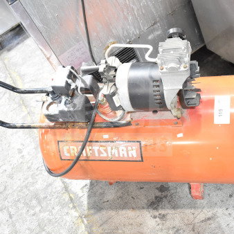 Craftsman Air Compressor, orange tank with black motor, used condition. Visible Craftsman logo on tank, item labeled "115".