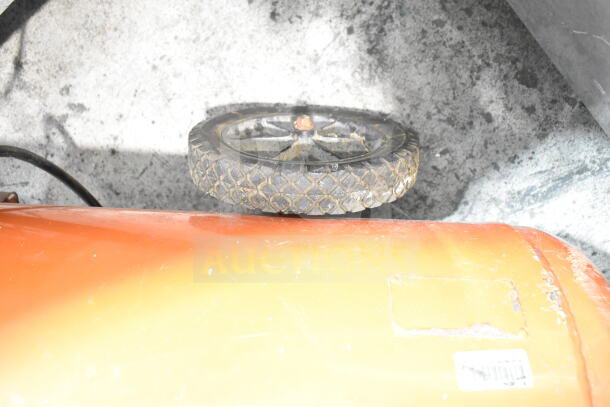 Craftsman air compressor with visible worn tire, orange tank partially visible, fair condition, barcoded label present.