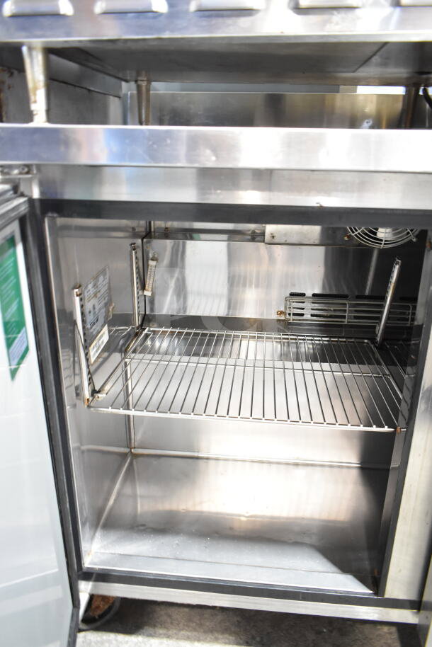 Turbo Air TWR-48SD commercial undercounter cooler, two-door, on casters. Interior view, shows stainless shelves and label.