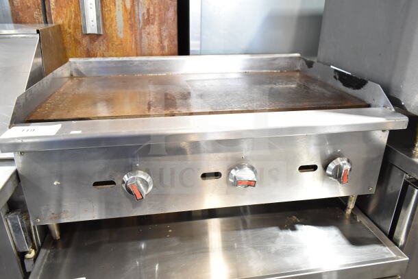 Commercial countertop gas-powered flat top griddle with three control knobs, stainless steel, used condition.