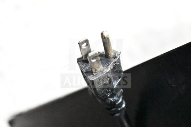 A close-up of a three-prong plug for a 115V Coldline CB36 commercial chef base.