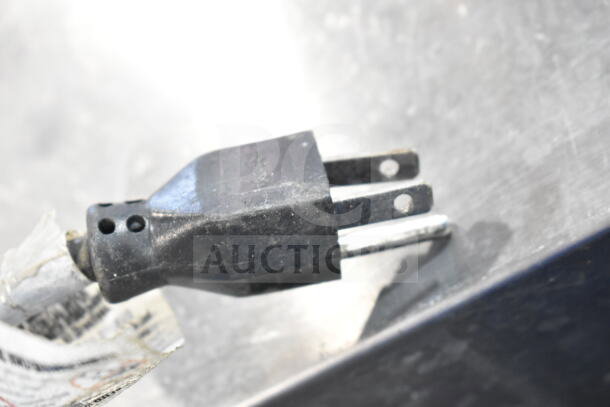 Close-up of a black electrical plug attached to the Beverage Air SP72-30M prep table, showing wear.