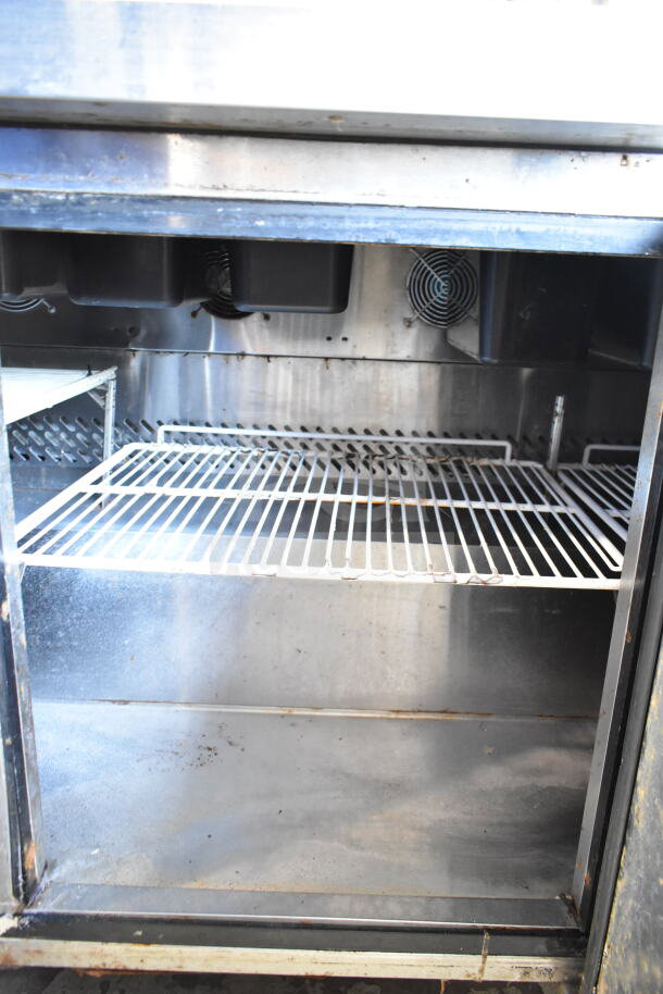 Atosa MSF8304GR Commercial Sandwich Salad Prep Table, stainless steel shelves, visible wear, 115V, on casters.