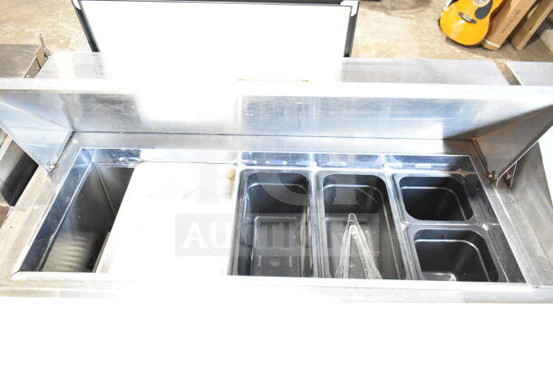 Atosa MSF8304GR prep table with bain marie top, visible stainless steel finish, multiple food compartments, on commercial casters.