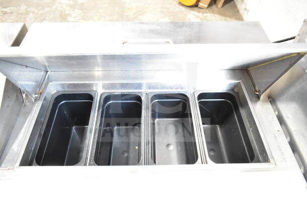 Atosa MSF8304GR commercial sandwich salad prep table with bains marie top and casters, featuring four empty trays.
