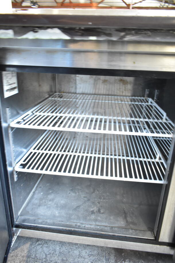 2018 Atosa MPF8202GR commercial pizza prep table interior with wire shelves, on casters, 115 volts, 1 phase.