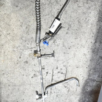 Industrial faucet with spray nozzle and flexible hose, stainless steel finish, model 130 on handle, good condition.