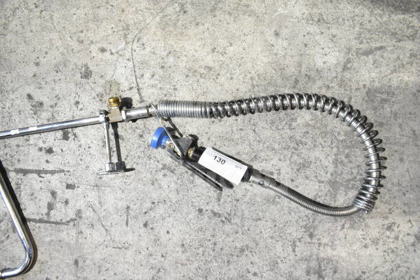 Chrome faucet with a blue spray nozzle attachment and coiled hose. Label reads "130". Ideal for commercial use.
