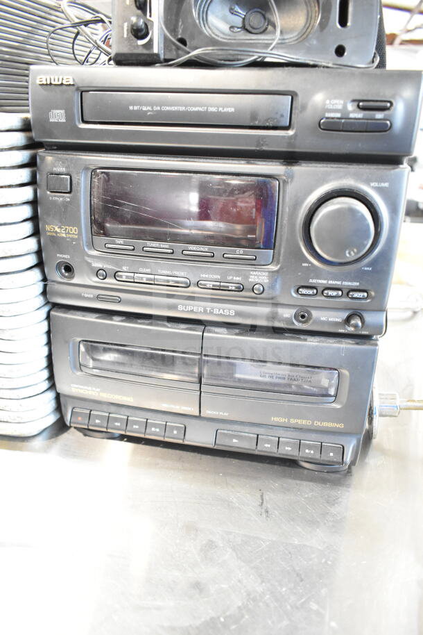 Aiwa CX-N2700U Compact Disc Stereo System with 4 speakers, 120V, 1 phase. Features dual tape decks, Super T-Bass, visible wear.